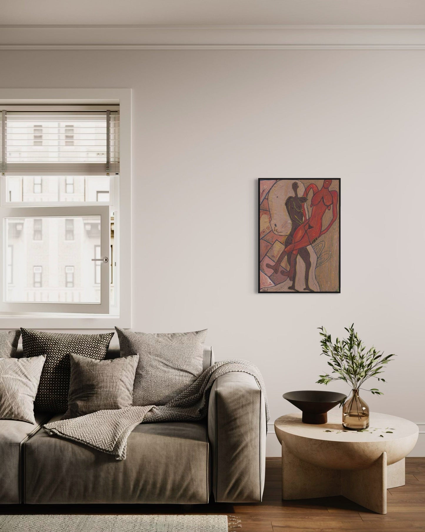 Living room with a gray sofa, small table, and wall art.