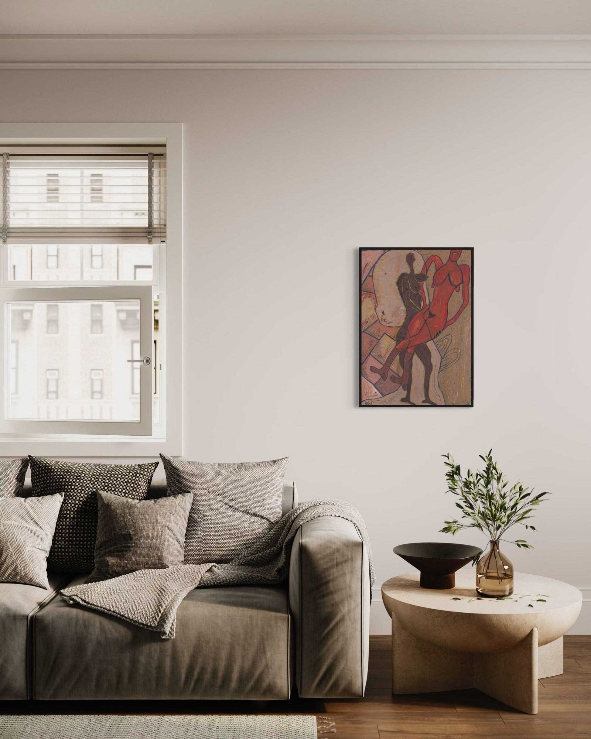 Living room with a gray sofa, small table, and wall art.