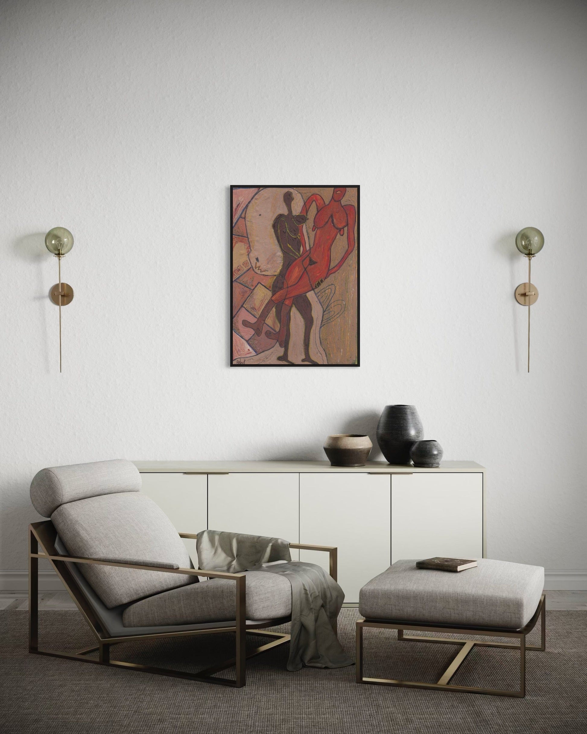 Modern living room with a gray armchair, ottoman, and wall art.
