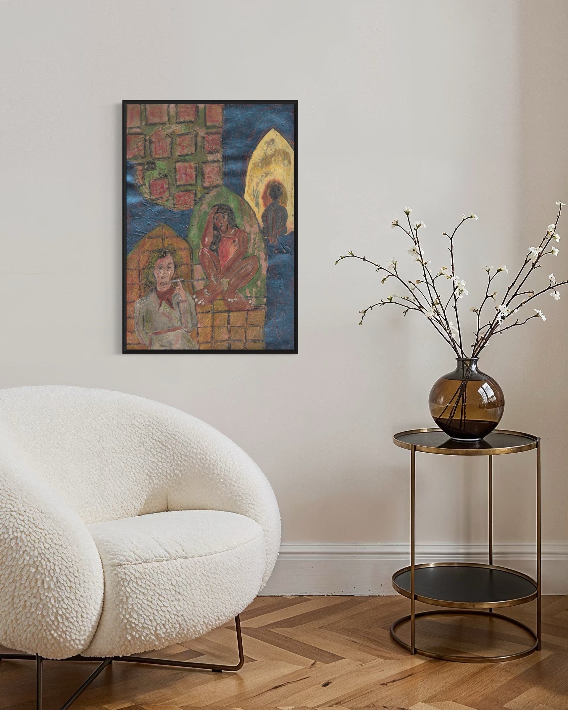 Modern living room with a white armchair, side table with a vase, and wall art.