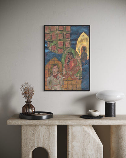Framed artwork on a wall above a console table with decorative items.