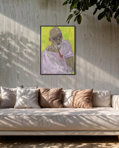 Framed artwork of a figure with a green background on a wall above a sofa.