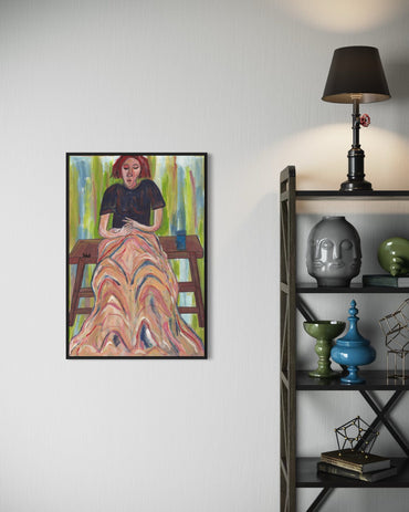 Framed artwork of a woman on a wall next to a shelf with decorative items.