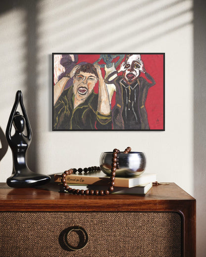 Framed artwork of two figures on a wall above a wooden surface with decorative items.