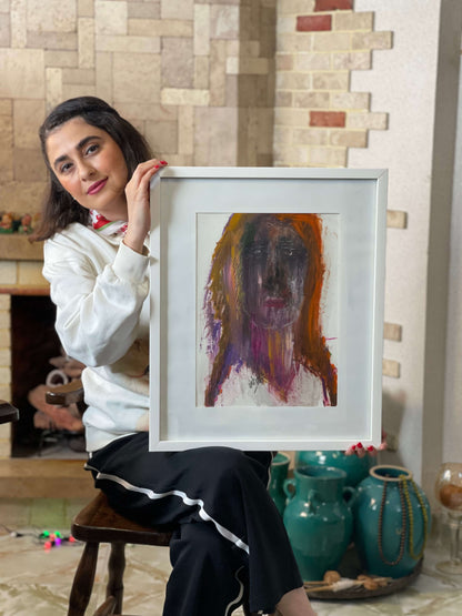 Woman holding a framed painting in a room with decorative elements.