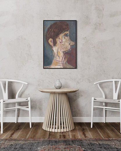 Framed artwork on a wall above a wooden side table with two white chairs.
