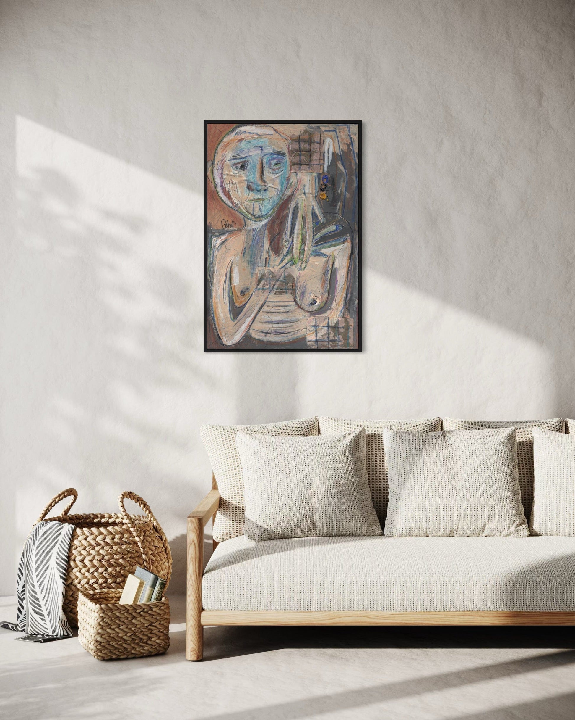 Framed abstract artwork above a sofa in a living room setting