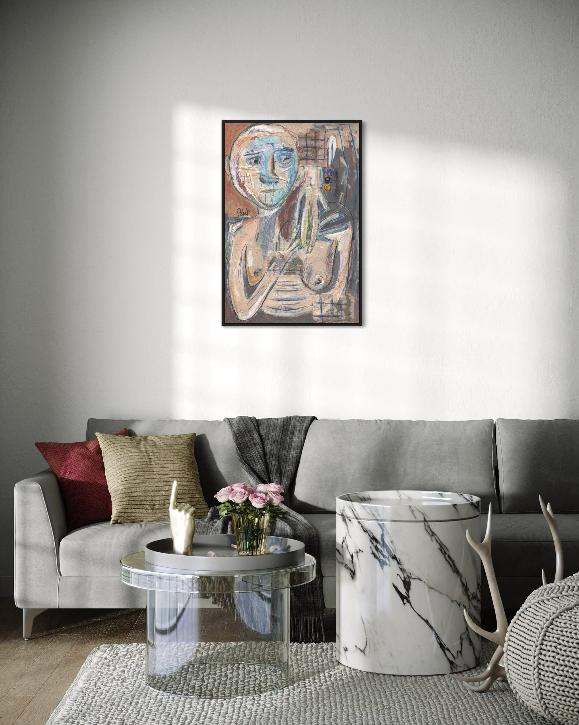 Living room with a gray sofa, coffee table, and decorative items, featuring a framed painting on the wall.