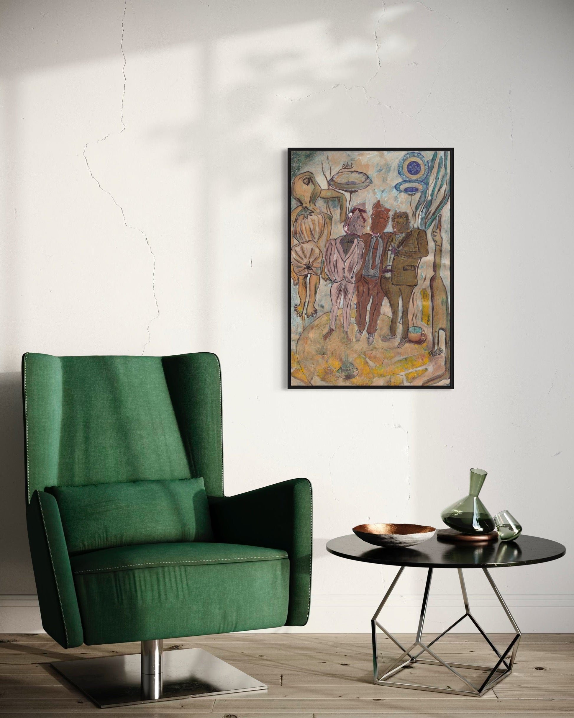 Green armchair in a room with a table and artwork on the wall