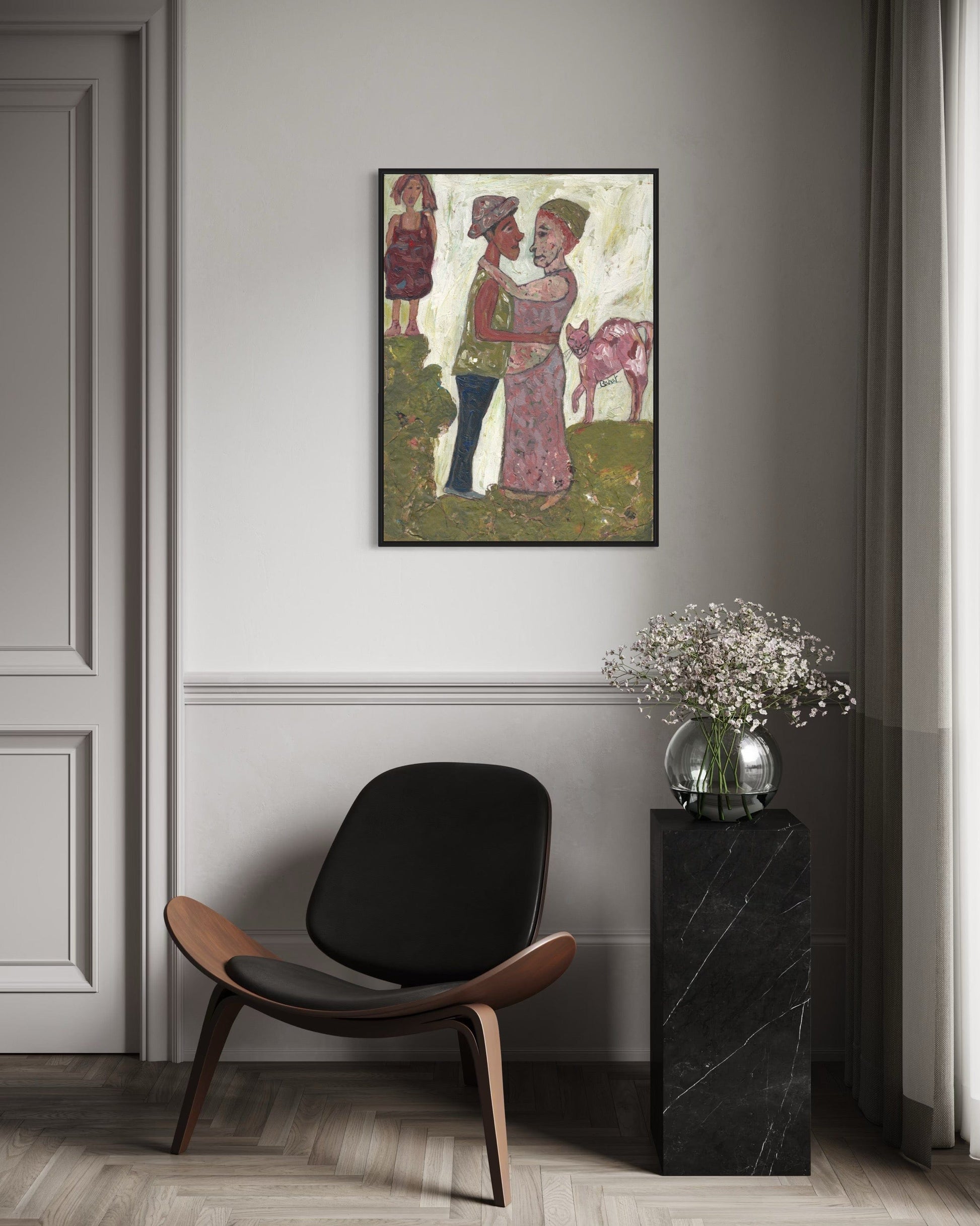 Modern interior with a black chair, side table, and framed artwork on a gray wall.