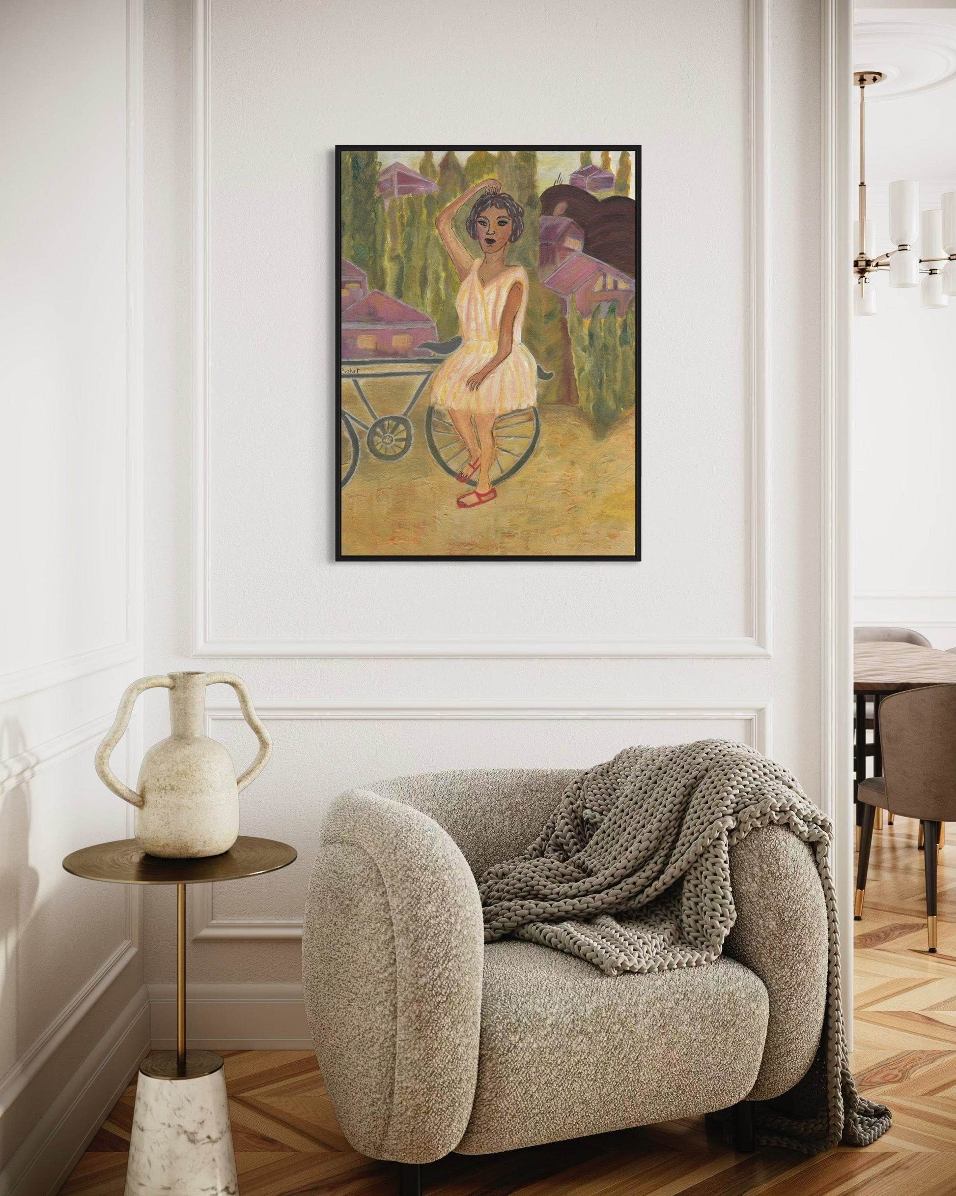 Living room with a textured armchair, small table, and framed artwork on the wall.