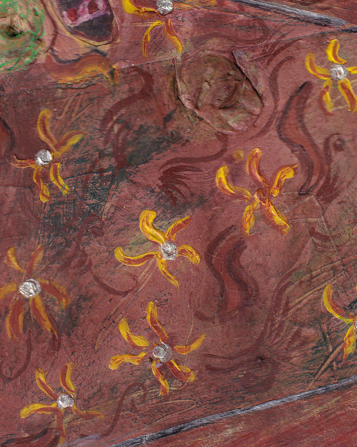 Decorative wooden surface with floral patterns and embedded stones