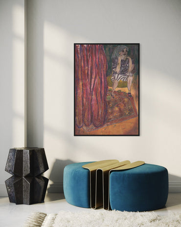Modern interior with a blue ottoman, geometric black vase, and framed artwork on the wall.