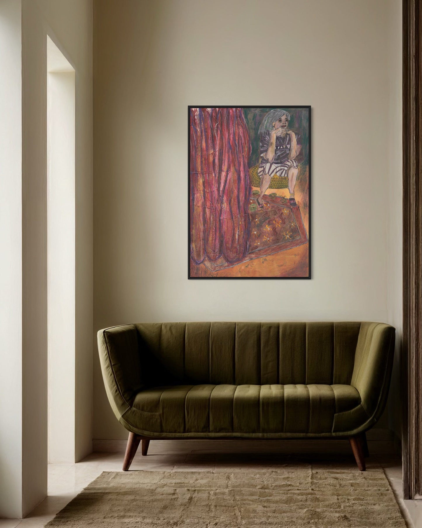 Green sofa in a room with a painting on the wall