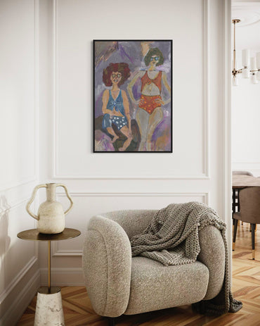 Living room with a beige armchair, side table, and abstract painting on the wall.