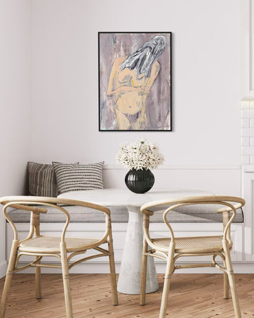 Dining room with wicker chairs, a small table, and a decorative painting on the wall.