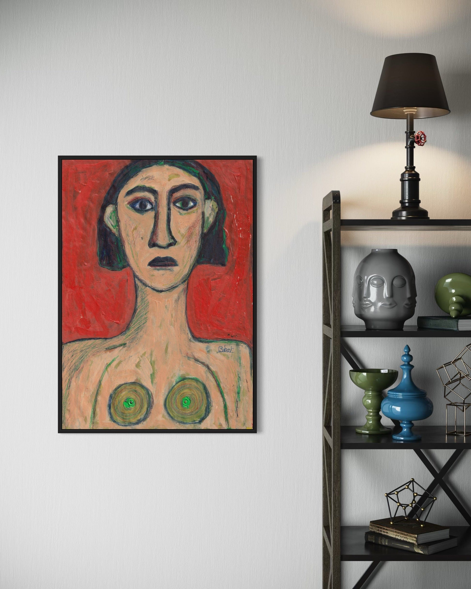 Framed artwork on a wall next to a shelf with decorative items