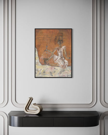 Framed artwork on a wall above a black console table with decorative item.