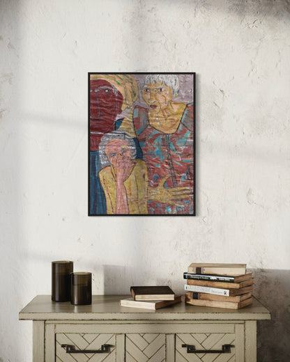 Framed artwork of two figures on a textured wall above a wooden cabinet with books.