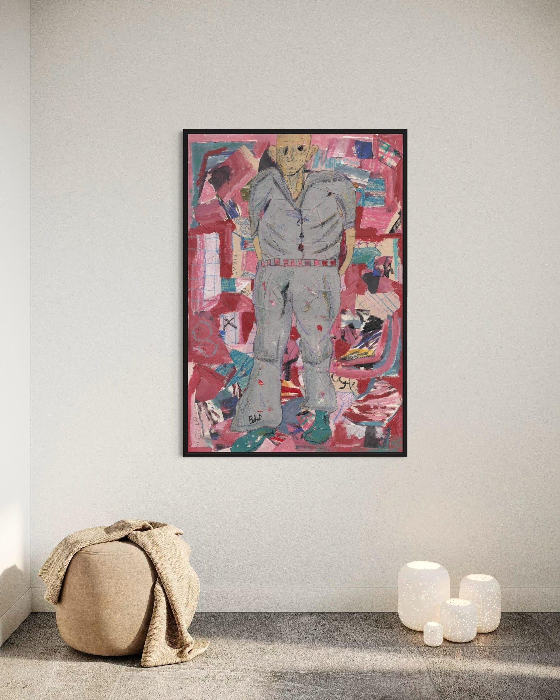 Abstract artwork of a person in a gray suit on a pink background, framed and displayed in a room.