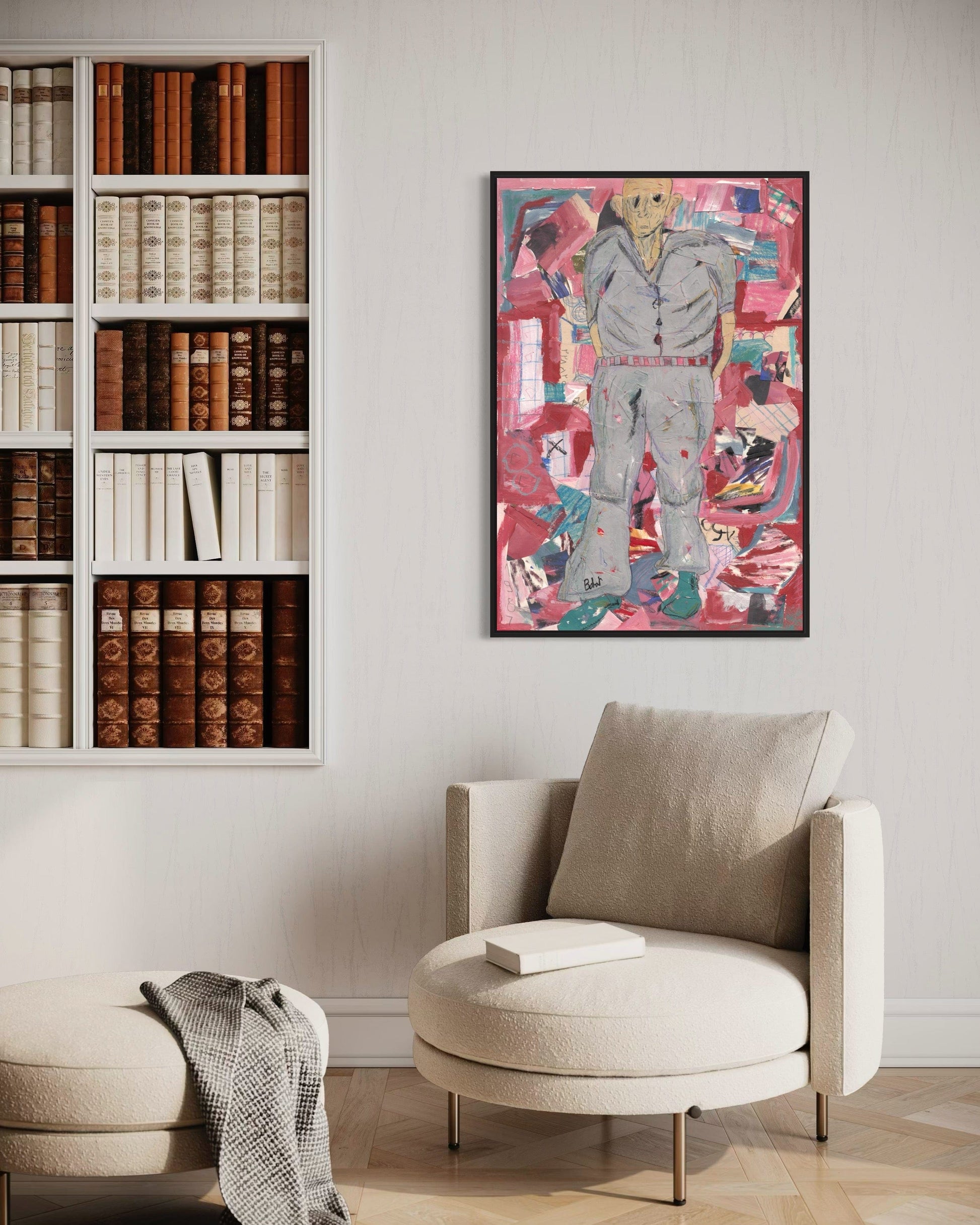 Modern interior with a bookshelf, armchair, and colorful abstract painting on the wall.