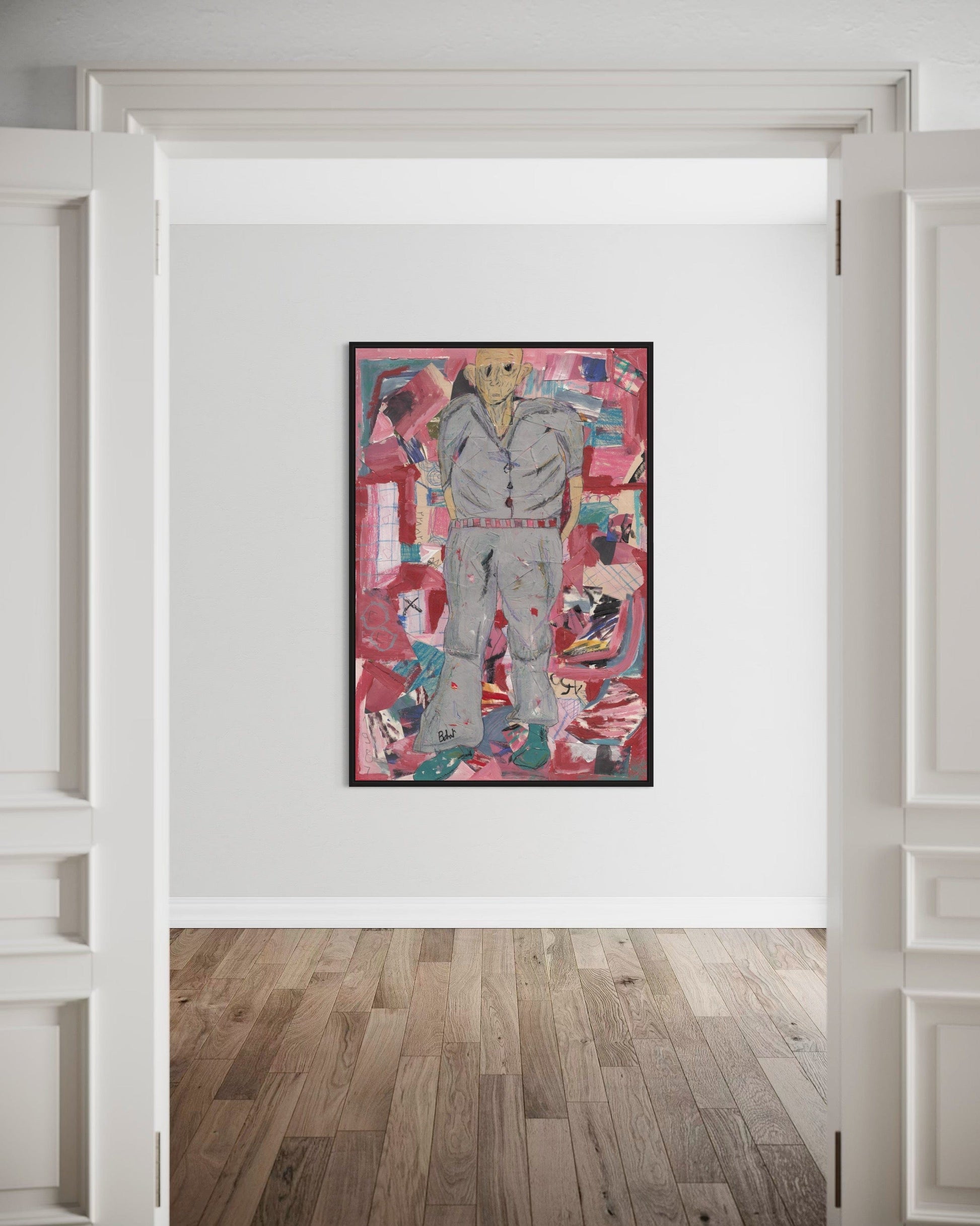 Framed abstract artwork on a white wall with wooden flooring.