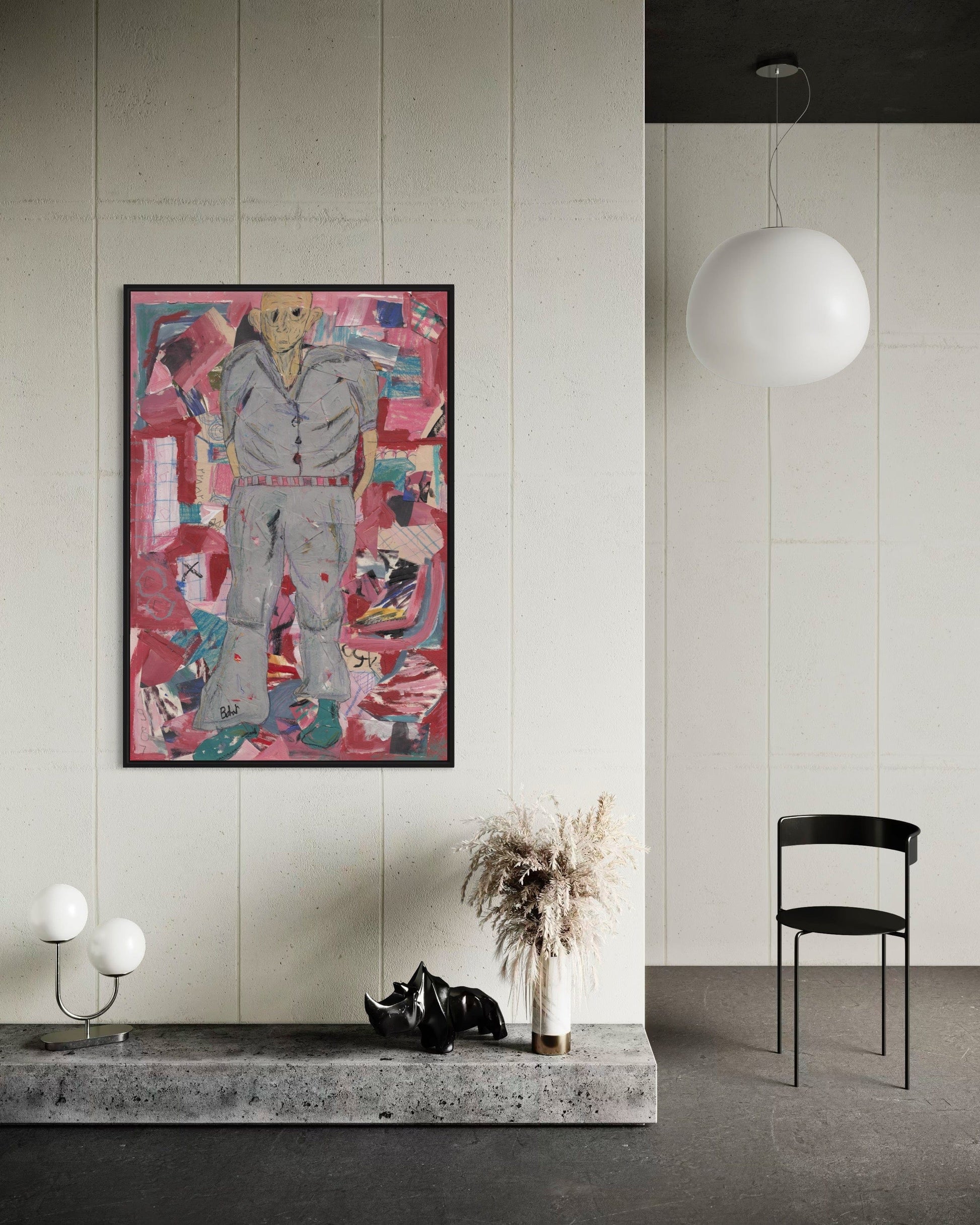 Modern interior with abstract artwork on a wall, black chair, and decorative items.