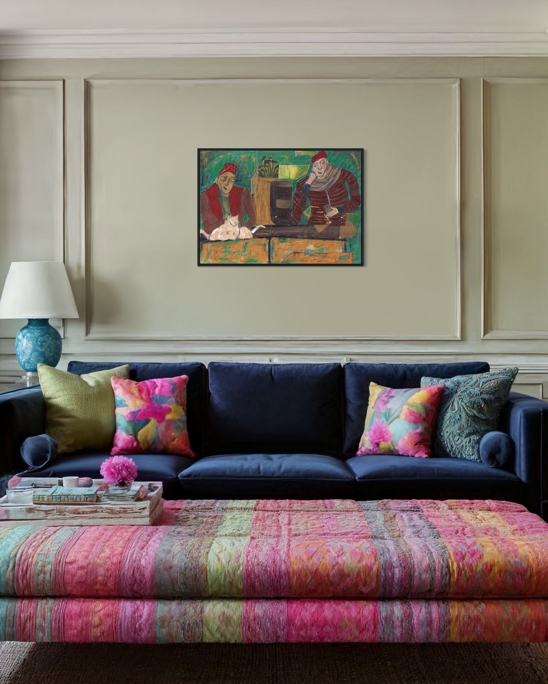 Living room with a navy blue sofa, colorful cushions, and a patterned ottoman.