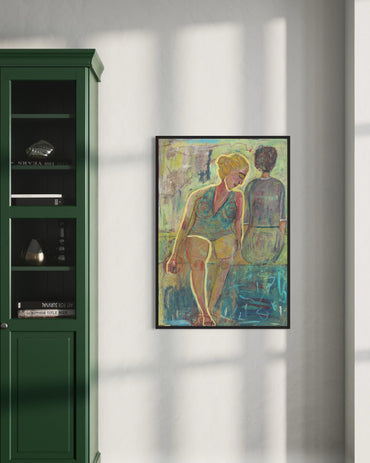 Framed artwork of two figures on a wall next to a green cabinet.
