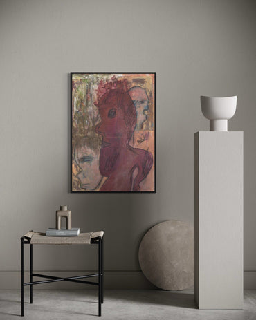 Artistic portrait on a wall with a side table and sculpture in a minimalistic room.