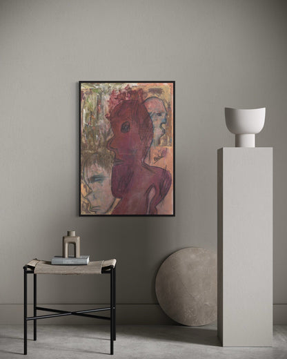 Artistic portrait on a wall with a side table and sculpture in a minimalistic room.