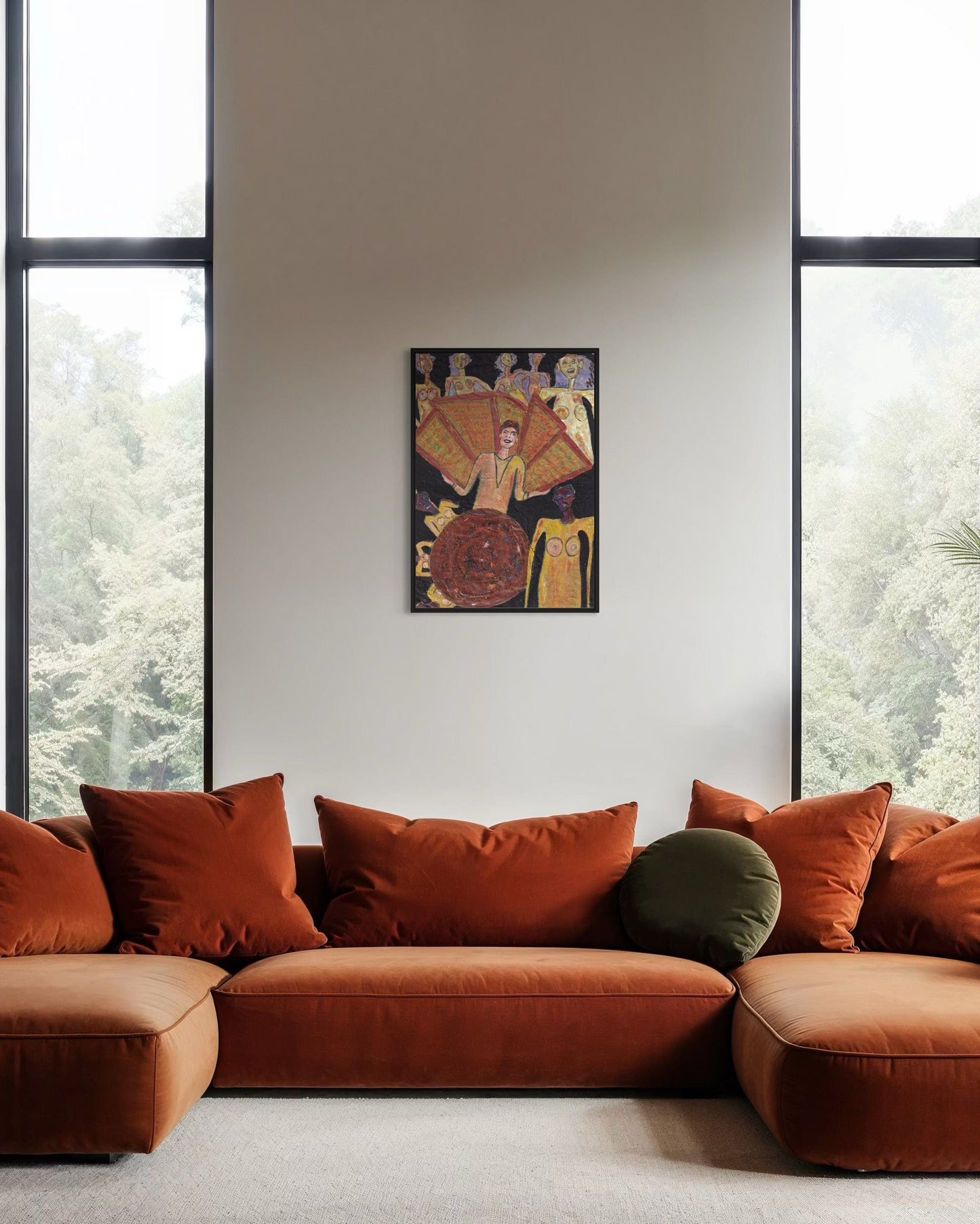 Orange sofa with decorative pillows in a room with large windows and a wall poster.