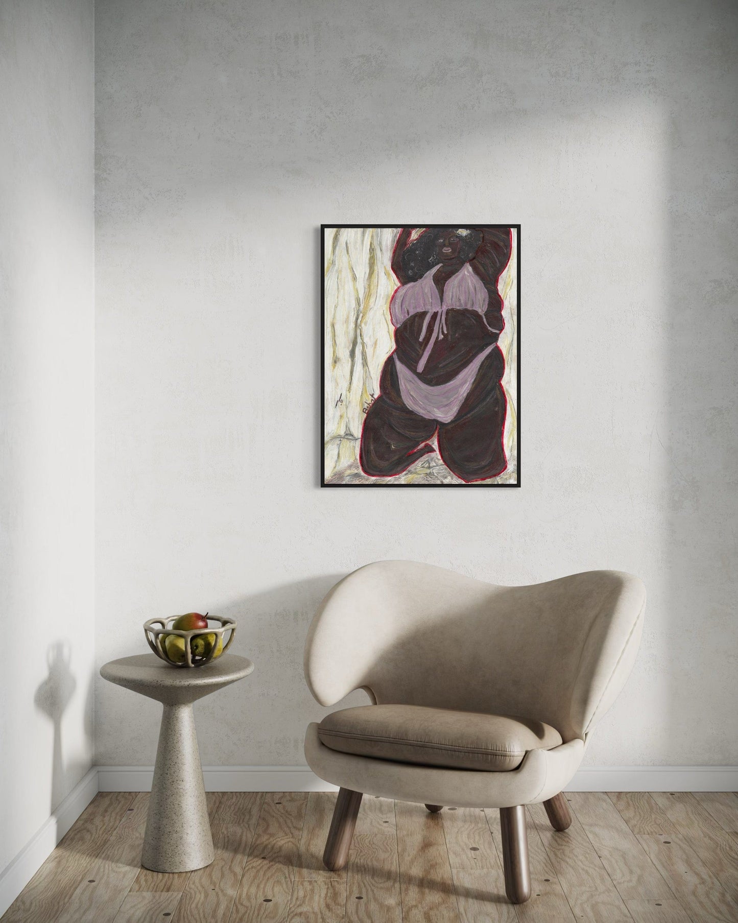 Beige armchair in a room with a wall painting and small table.