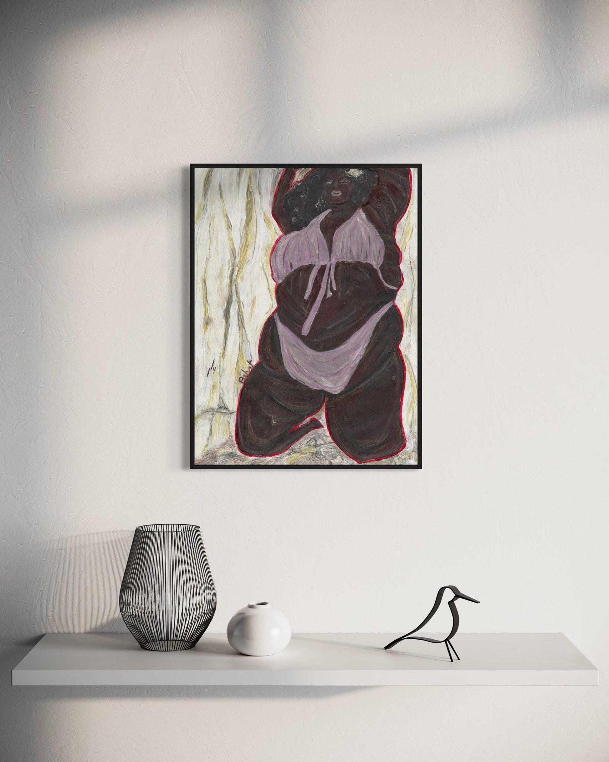 Abstract art piece on a wall above a white shelf with decorative items.