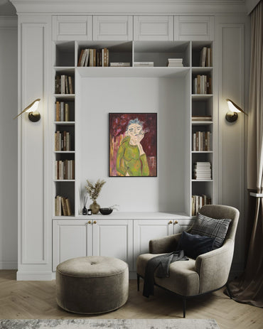 Modern living room with bookshelves, armchair, ottoman, and wall art.