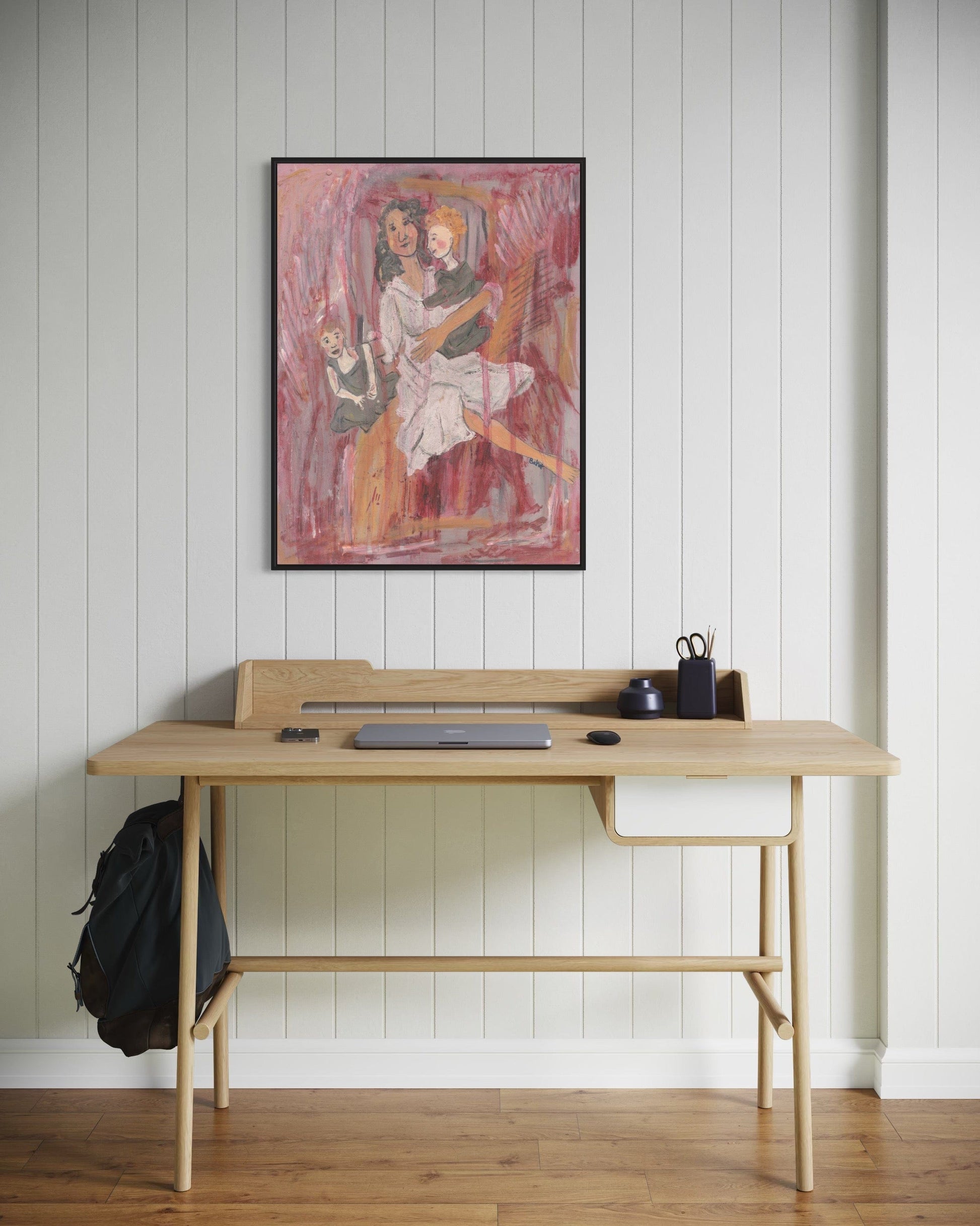Wooden desk with a backpack and items against a white paneled wall with a framed painting.