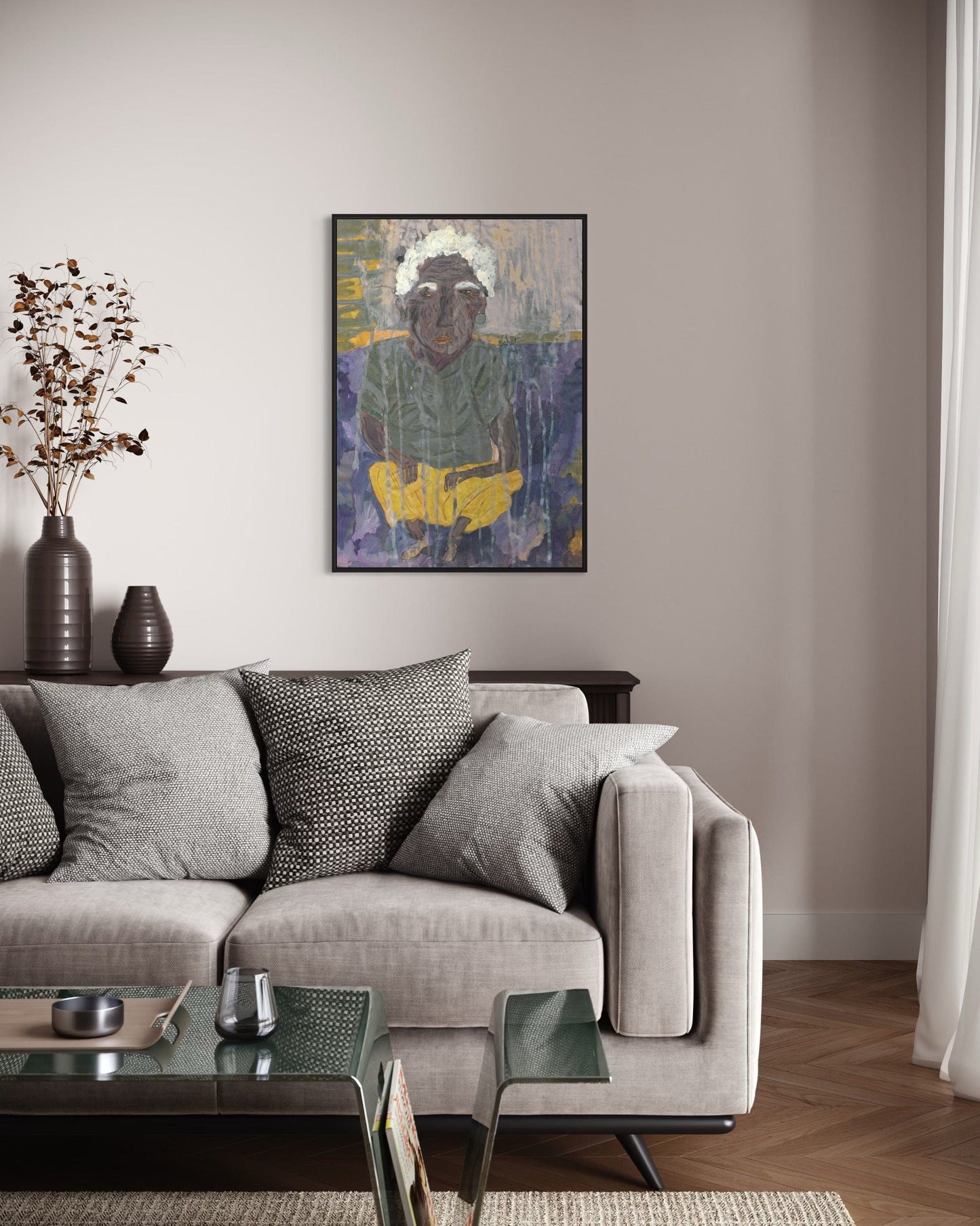Living room with a gray sofa, coffee table, and wall art.