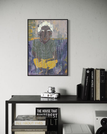 Framed artwork of a person on a wall above a shelf with books and decor items.