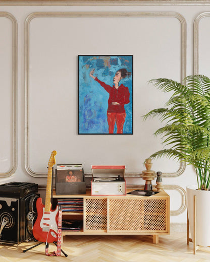 Living room with a wooden cabinet, guitar, and framed artwork on a wall.