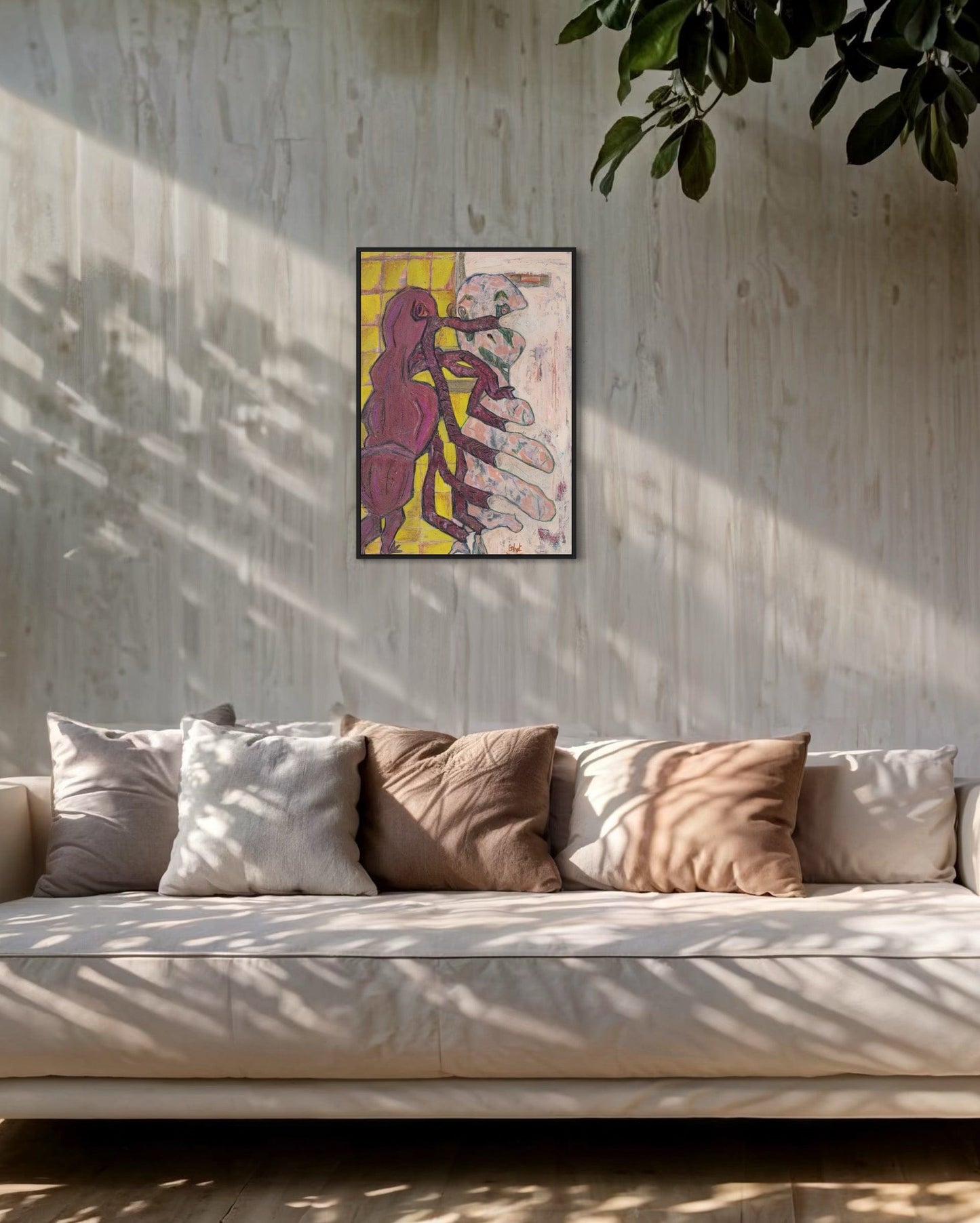 Framed abstract art on a wall above a sofa with cushions.