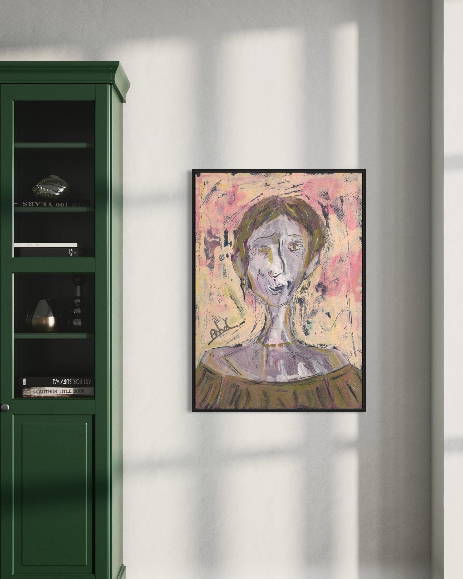 Framed abstract painting on a wall next to a green cabinet