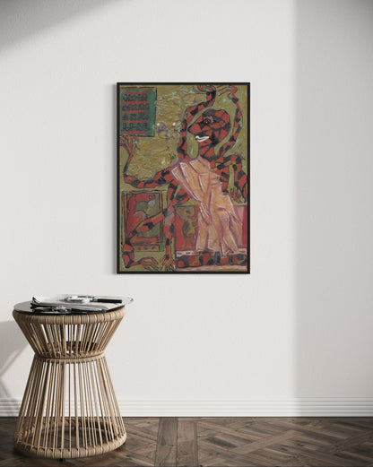 Framed artwork on a wall above a wicker side table in a room.