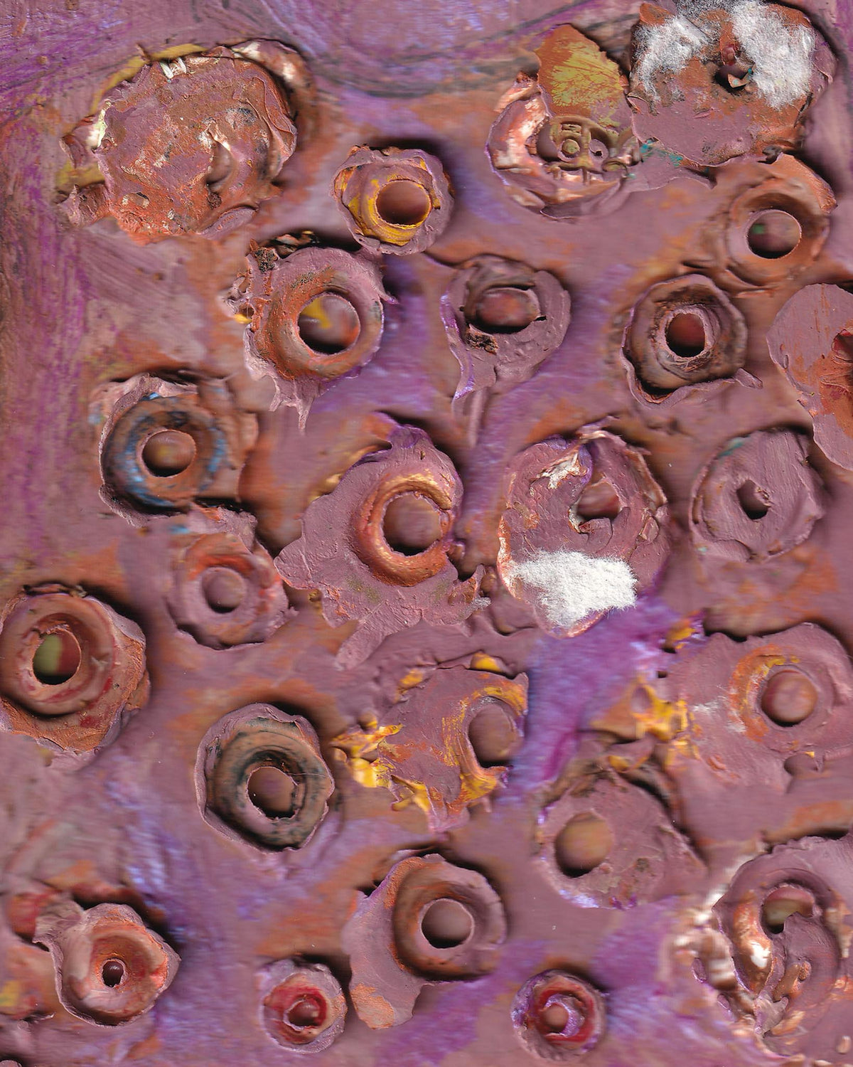 Close-up of rusted metal surface with purple and brown colors