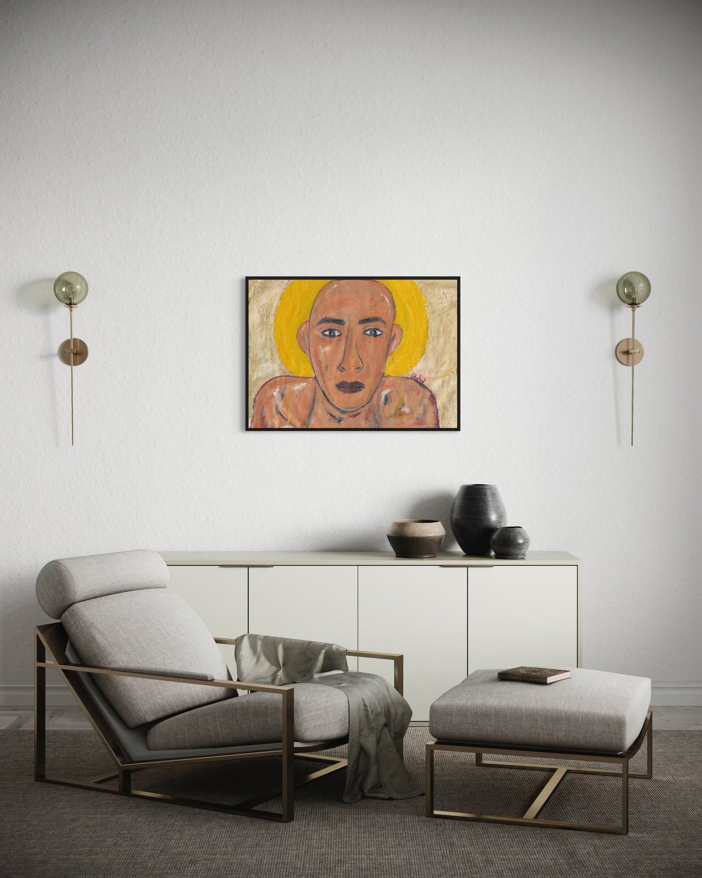 Modern living room with a gray armchair, ottoman, and wall art.