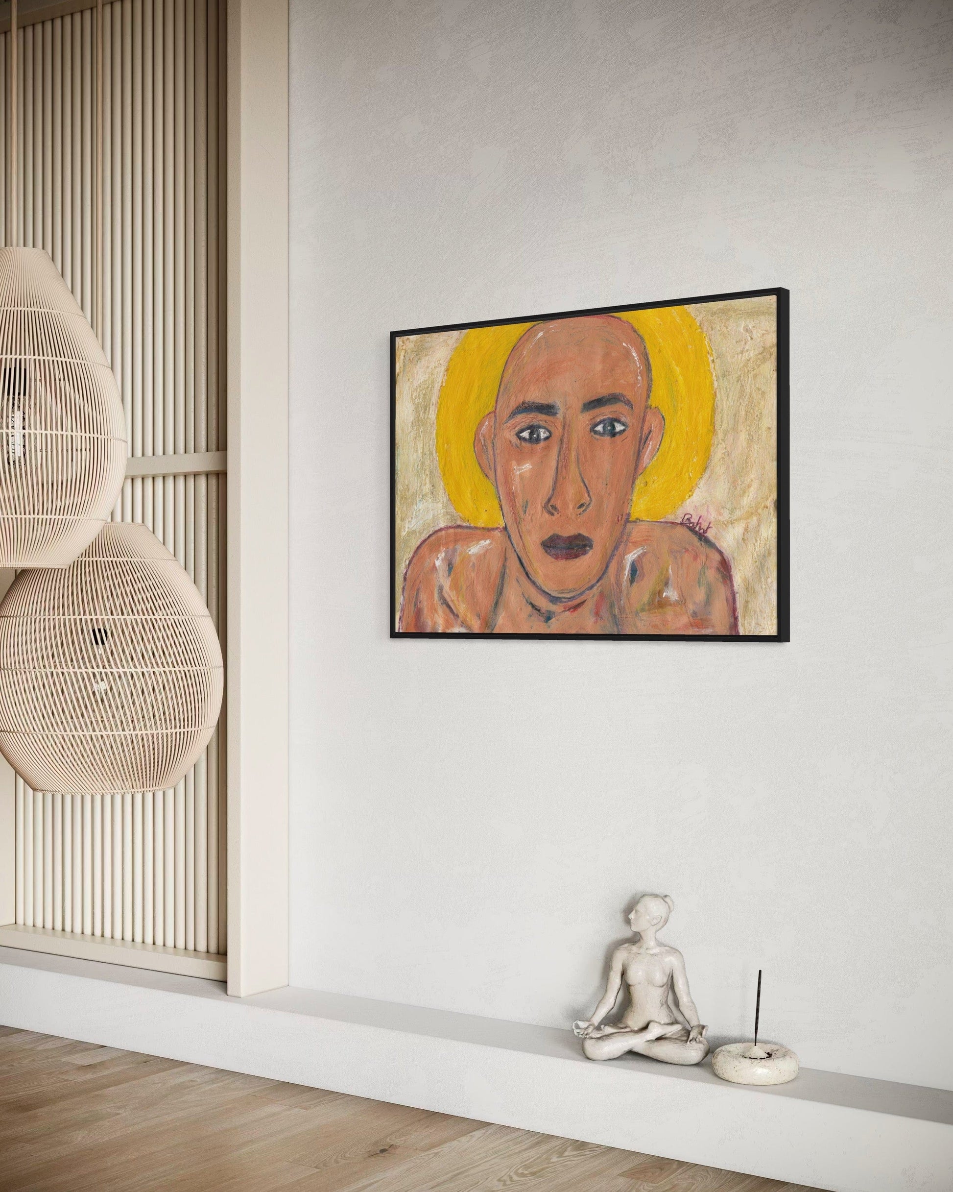 Framed artwork of a stylized portrait on a wall with minimal decor