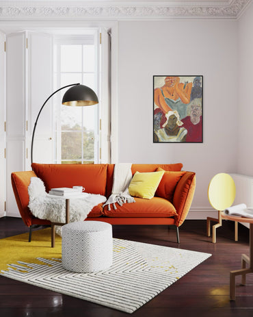 Modern living room with orange sofa, yellow rug, and decorative elements.