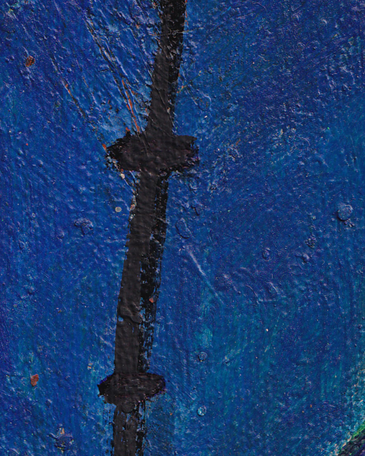 Close-up of a blue textured surface with a black line running vertically.