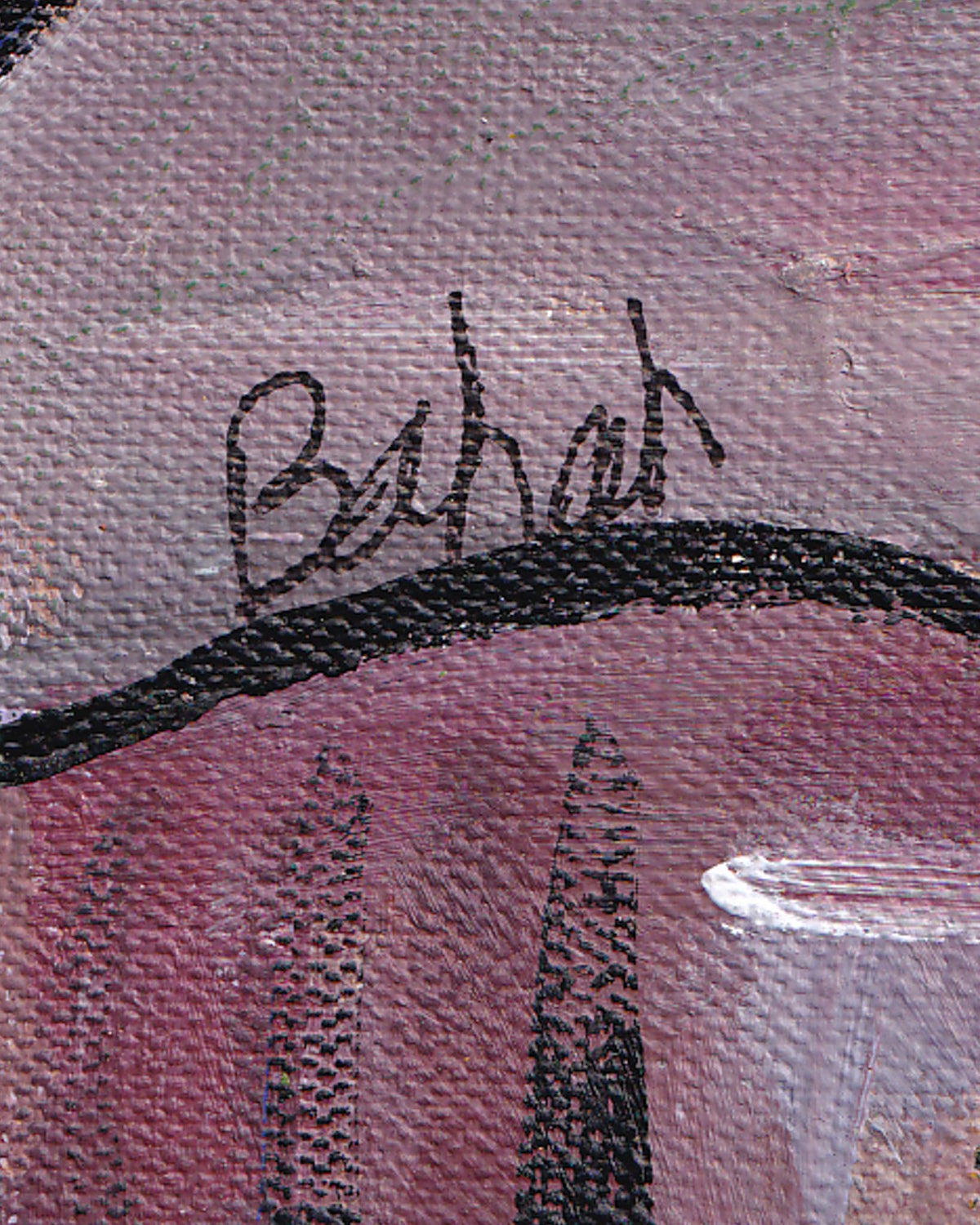 Close-up of a signature on a textured pink surface