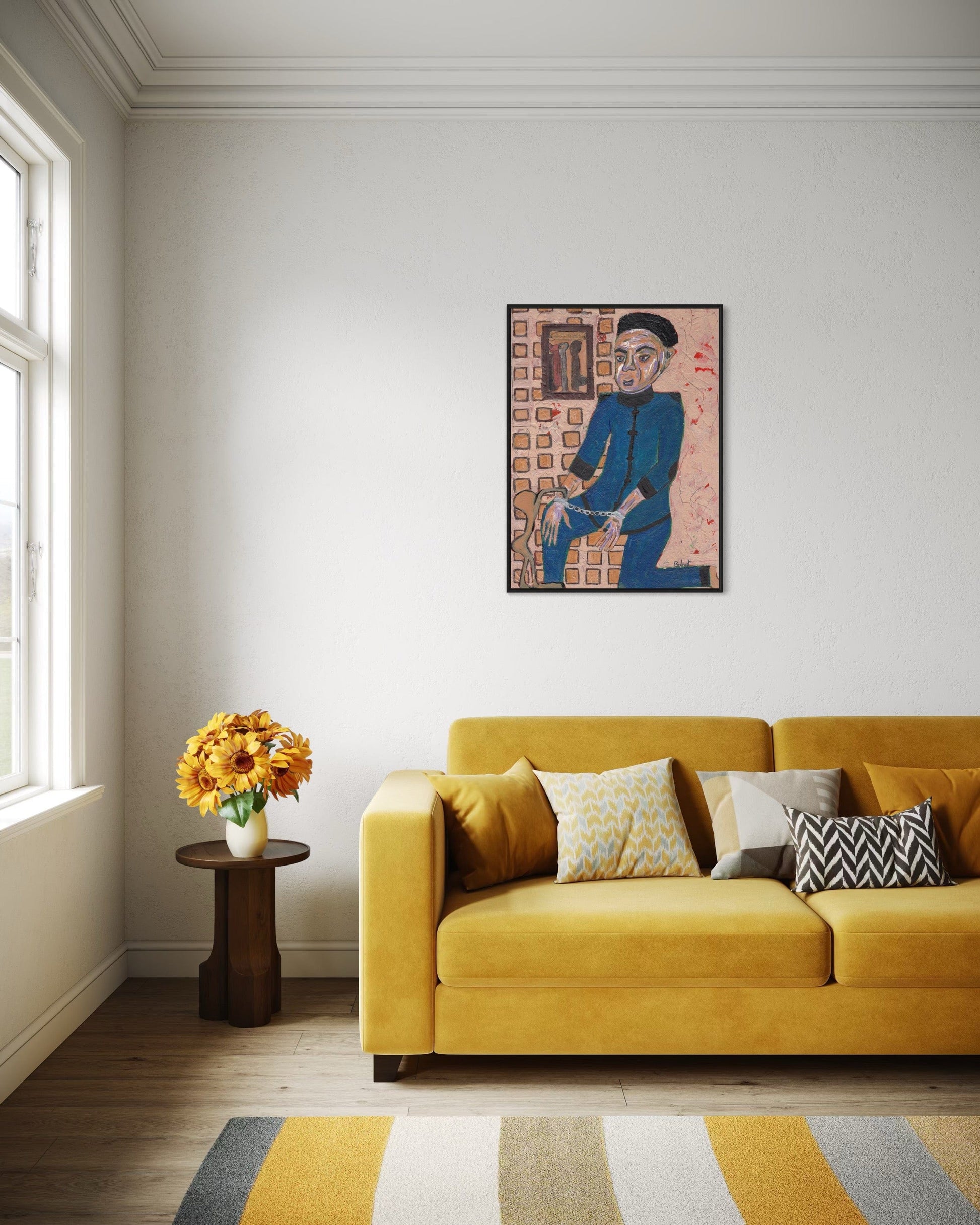 Living room with yellow sofa, side table with flowers, and framed artwork on the wall.