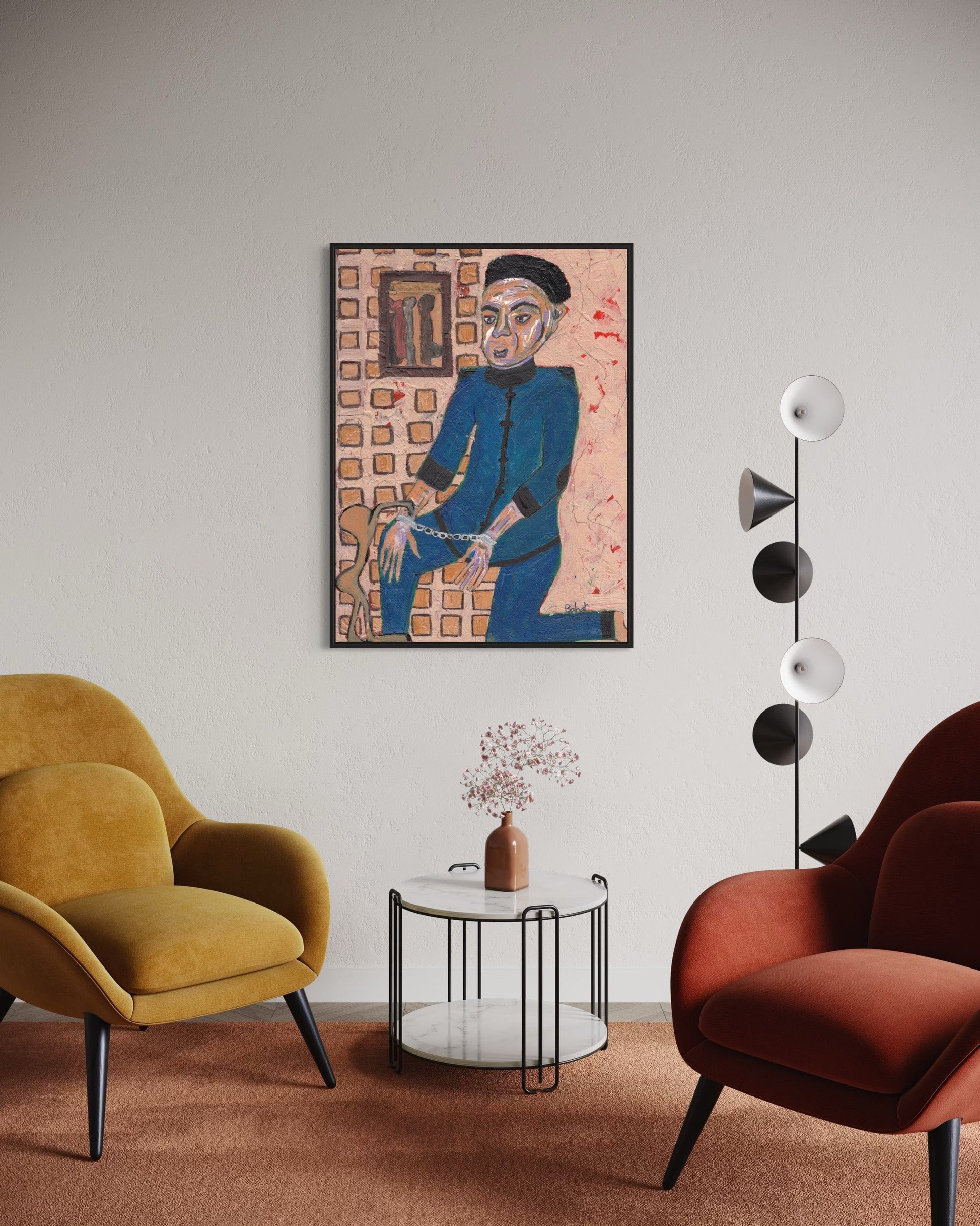 Modern living room with two armchairs, a side table, and a wall art piece.